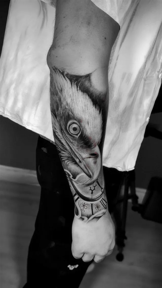 Eagle & clock, a forearm tattoo by Karan Sandhar