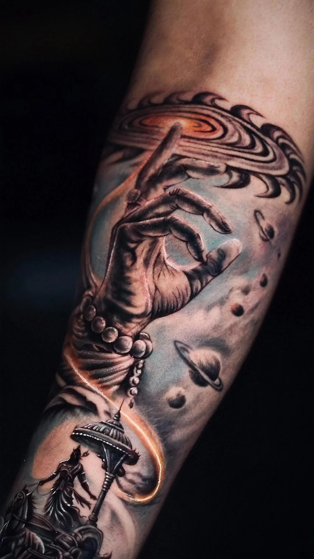 Close detail of a hand holding a chess piece among planets, tattoo by Karan Sandhar
