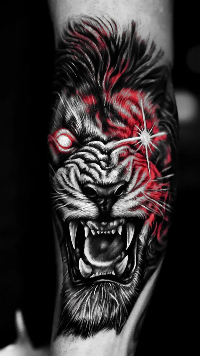 Red-eyed lion, a forearm tattoo by Karan Sandhar
